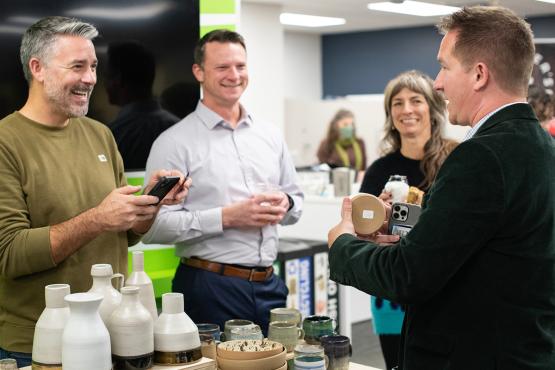 People talk and laugh at an entrepreneurship market.