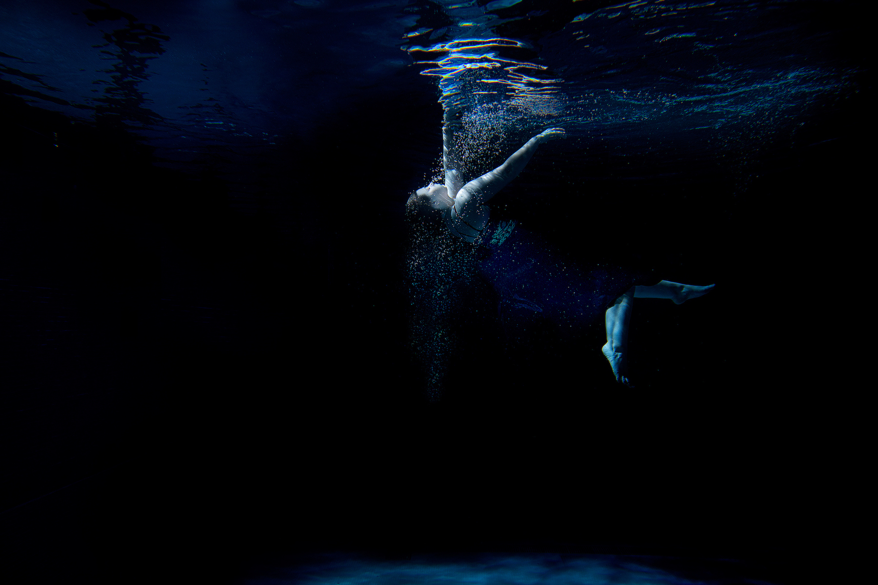 Person dancing underwater. 