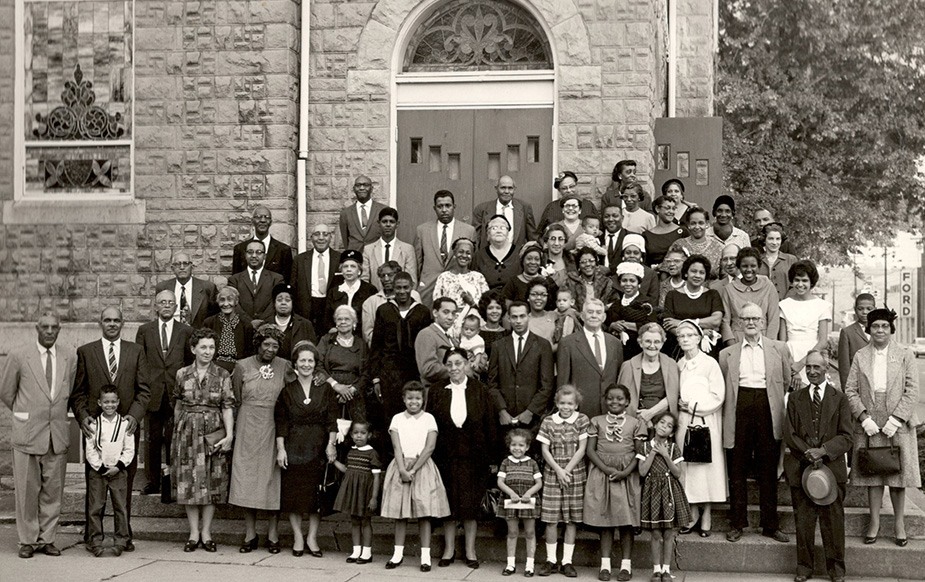 Historical photo of people standing in from of Mt. Zion Church
