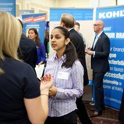 Woman talking to people at a conference