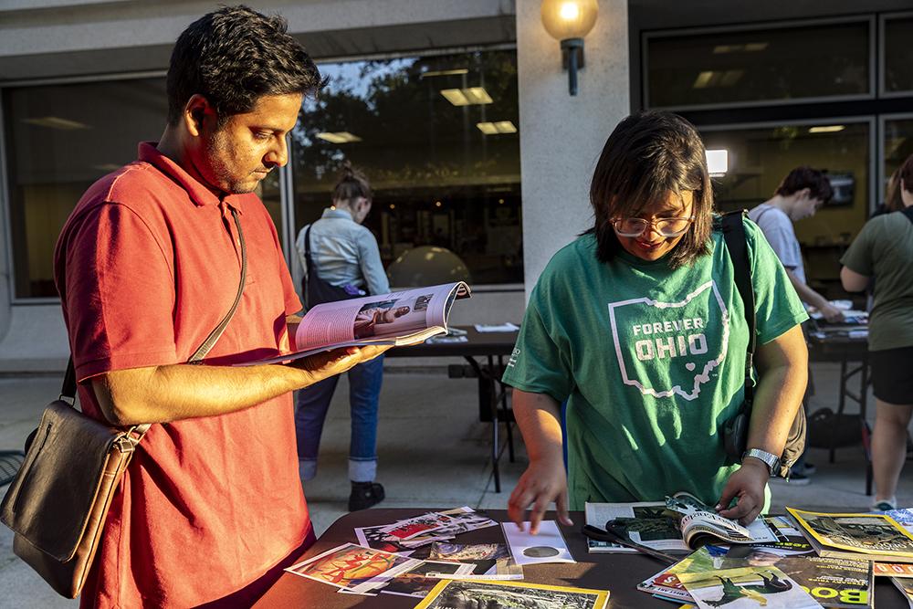 Photo of two people making buttons during Camp Alden 2023