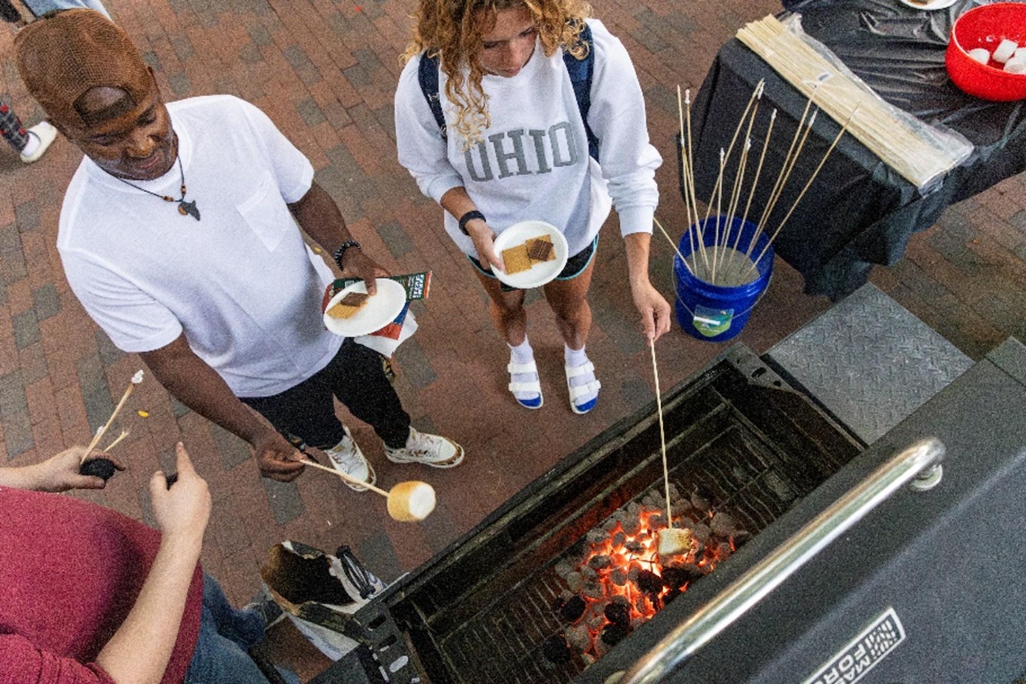 Picture of two students making smores