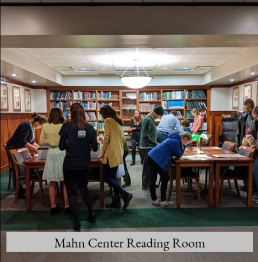 Group of people visiting the Mahn Center Reading Room with the words Mahn Center Reading Room at the bottom