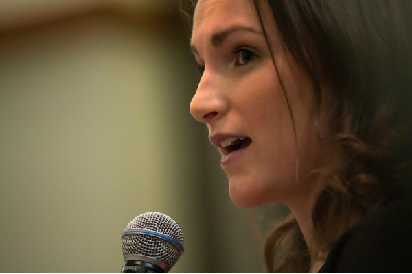 Woman speaking into microphone