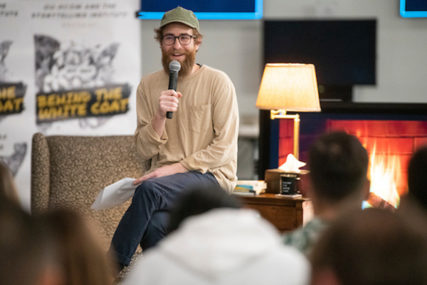 Man sitting and speaking into microphone