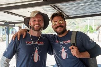 Two male HCOM students in Ecuador, smiling