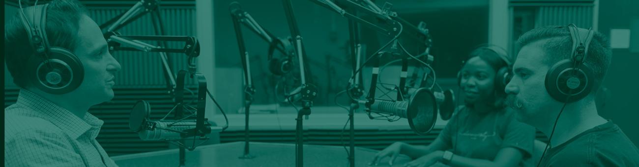 Three people sitting around a table, speaking into podcast mics, with a green overlay