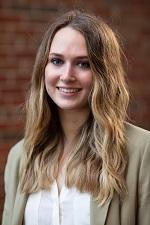 Young woman with light brown hair smiling