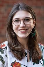 Young woman with brown hair and glasses