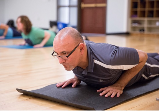 Participant mid  yoga pose transition