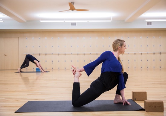 Participant holding yoga pose in classroom