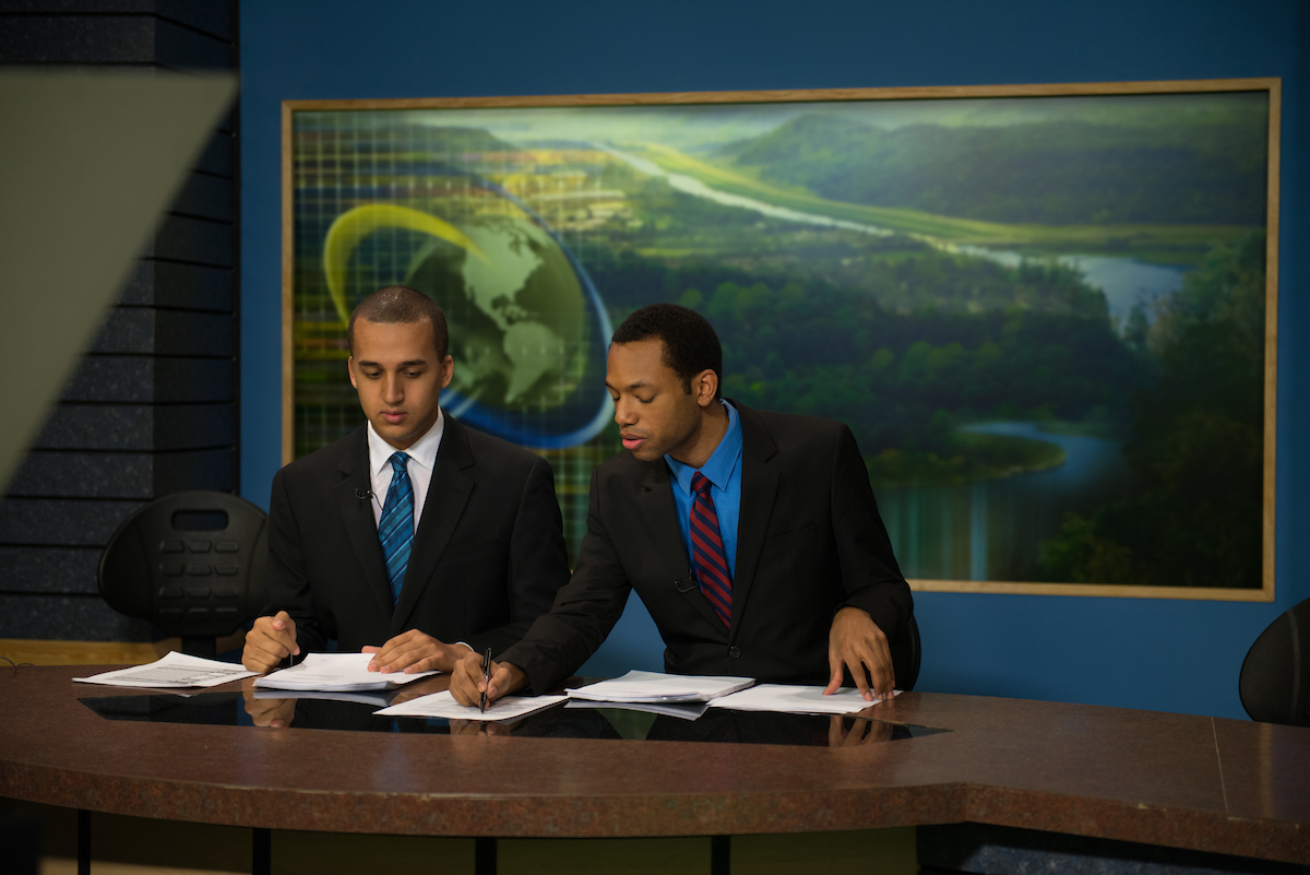 Students at broadcast desk