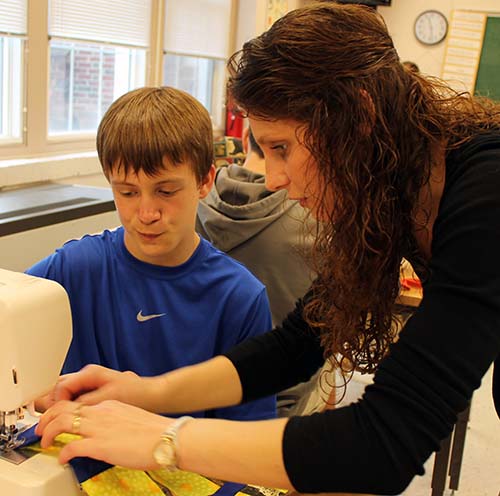 A Patton College student helps an elementary student in the classroom