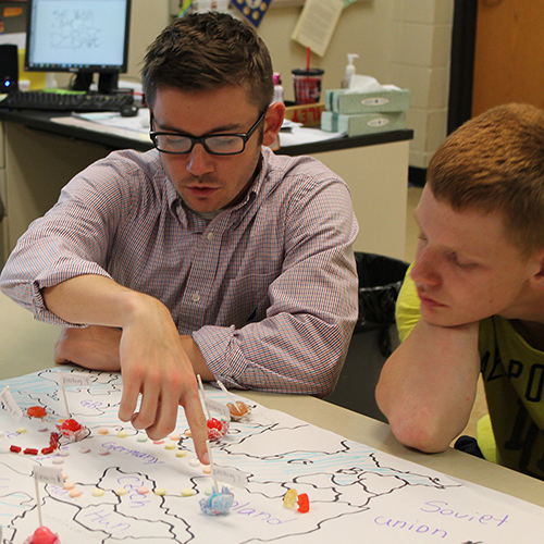 A Patton College student demonstrates an activity to an elementary student