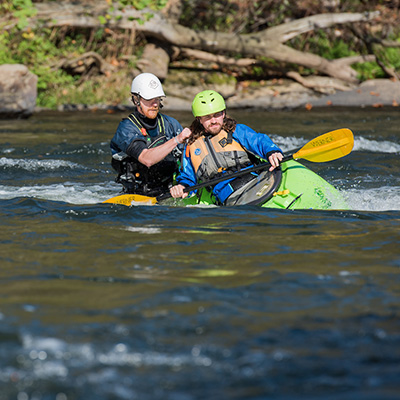 Students kayak on a river