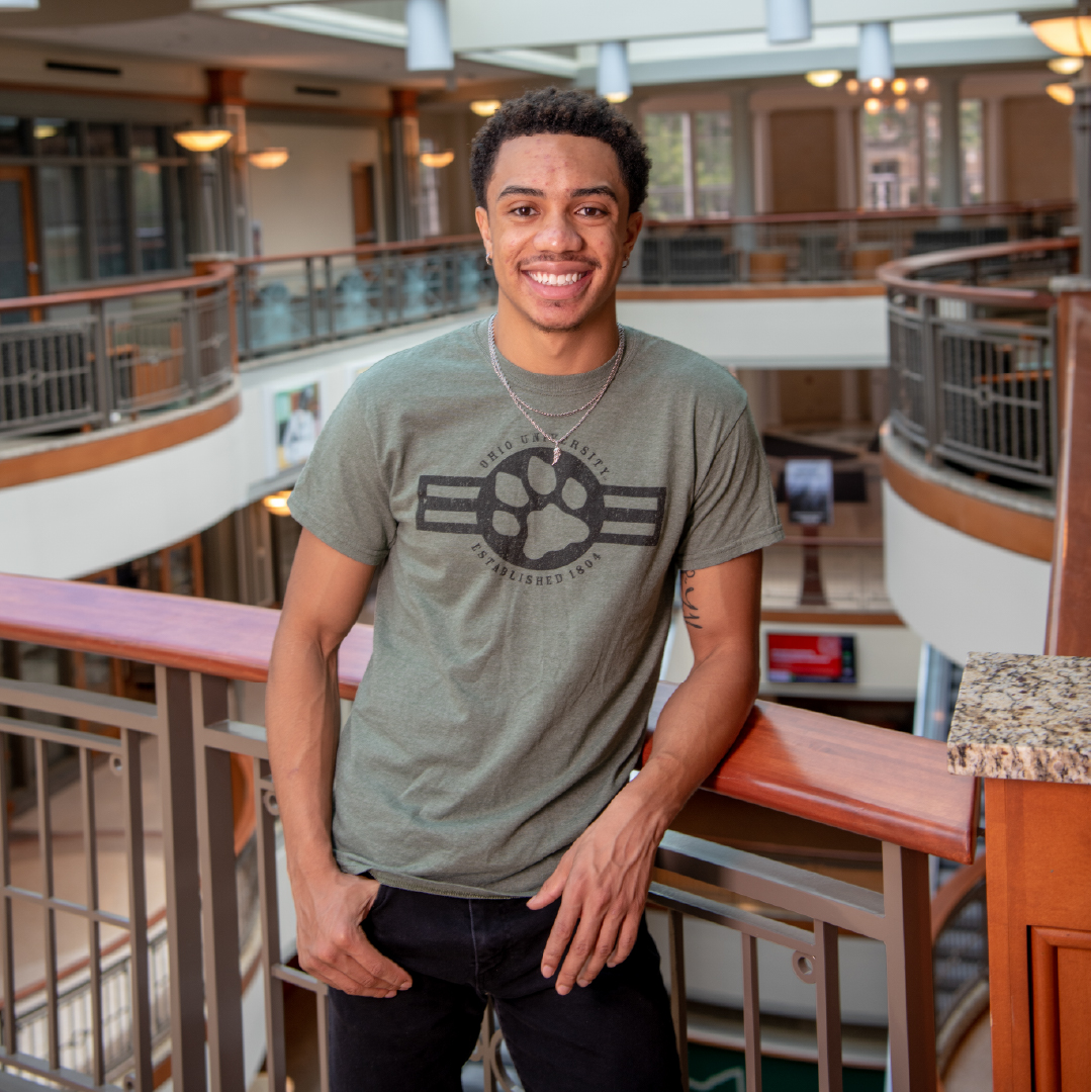 A student smiles at the top of Baker Center during a portrait