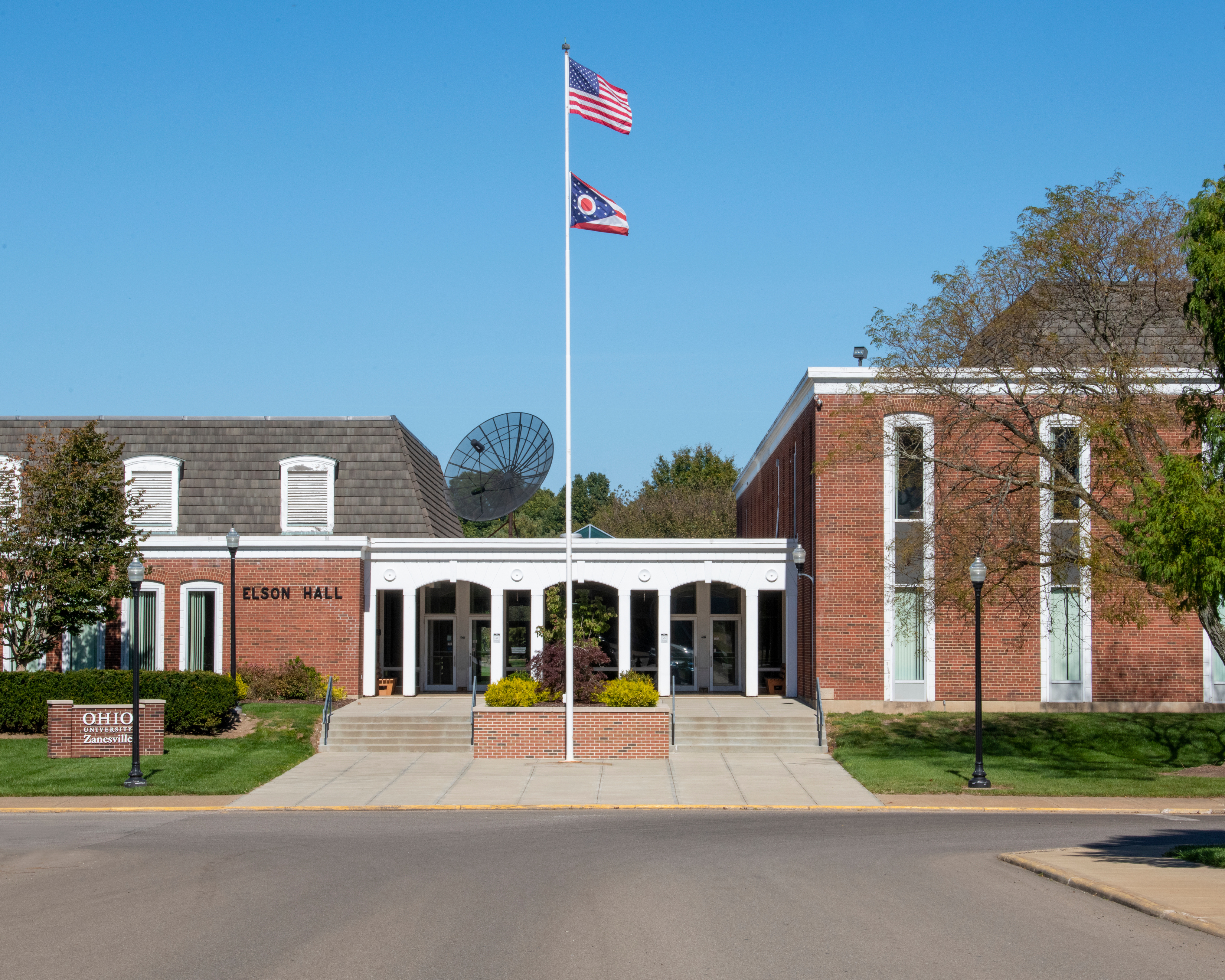 An image of Elson hall. A orange brick building with a white trim overhang entrance.