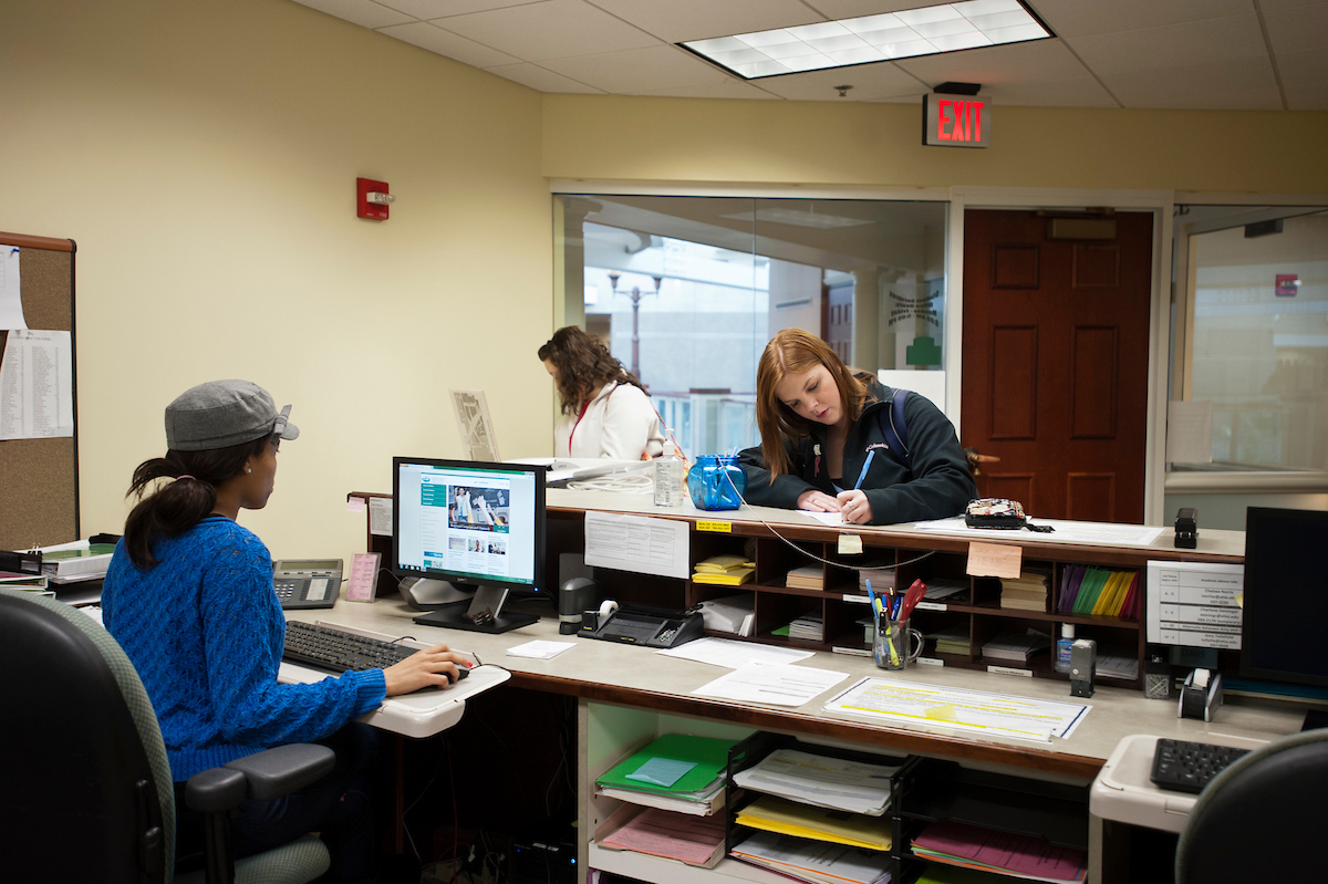 students at staff desk