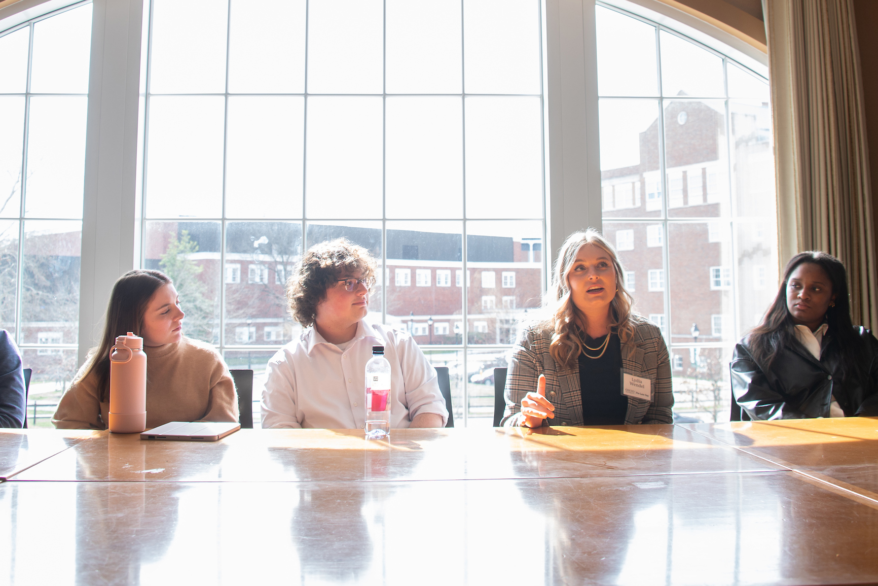 Four Pre-law Students sitting at a table discussing something. 