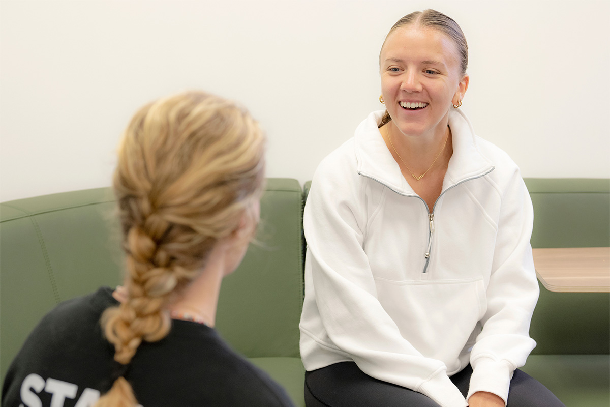 A well-being coach talks to a student about their well-being goals.