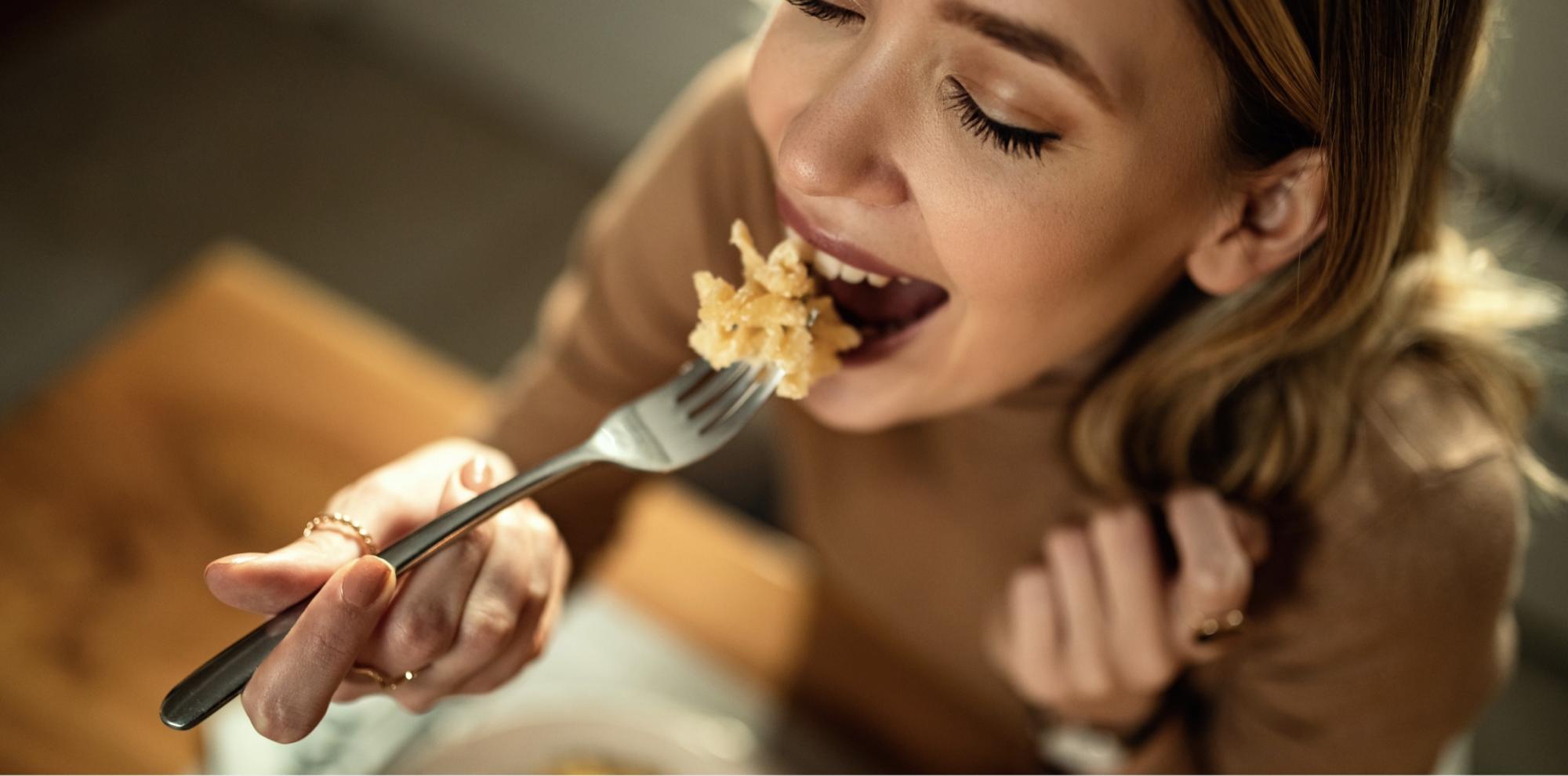 woman eating with eyes closed