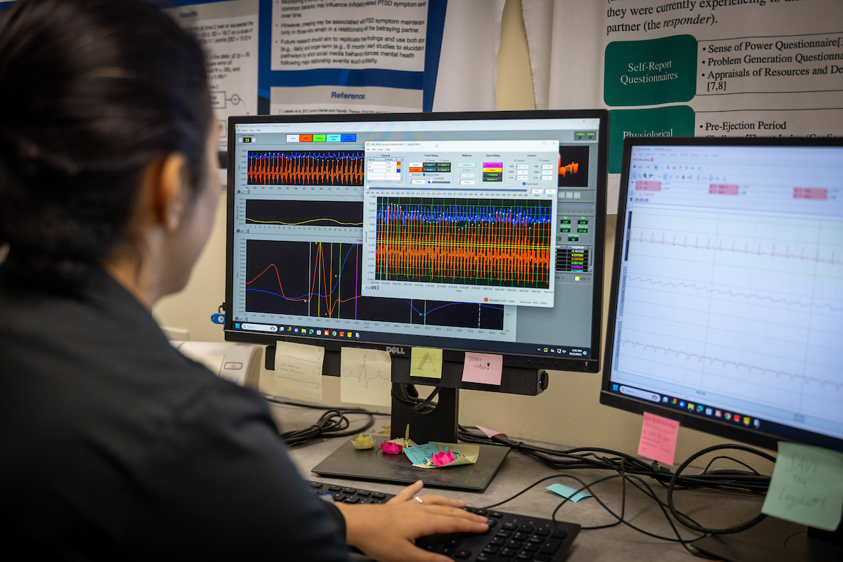 A person in front of two computer monitors