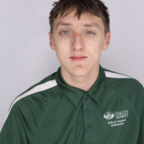 Tyler in a dark green Bobcat Student Orientation shirt, smiling at the camera.