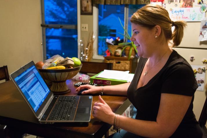 A student completes schoolwork on her laptop.