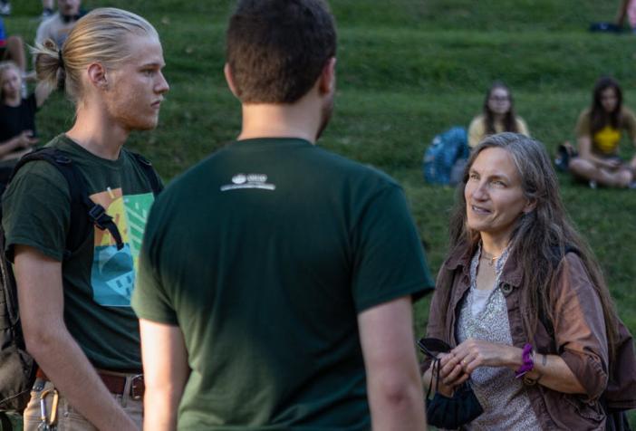 picture of three people discussing sustainability