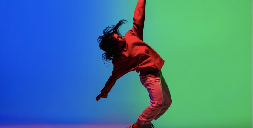 Person dancing hip hop with bright background