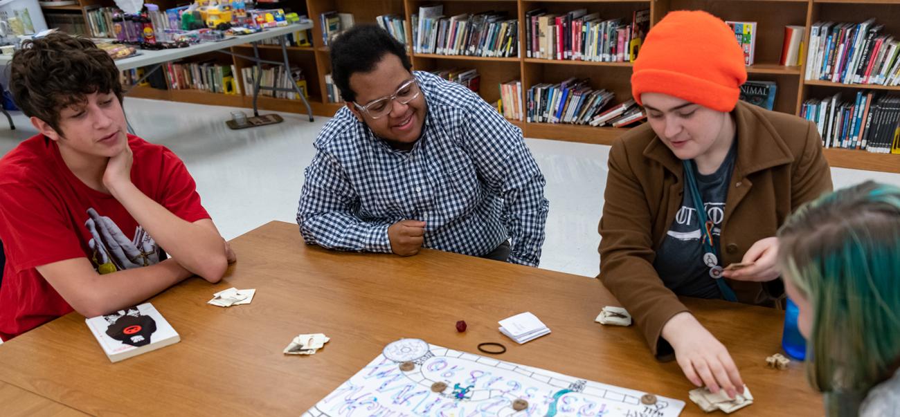 Students play a board game together