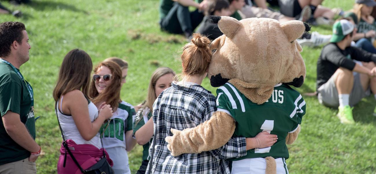 Ohio University student hugs Rufus Bobcat