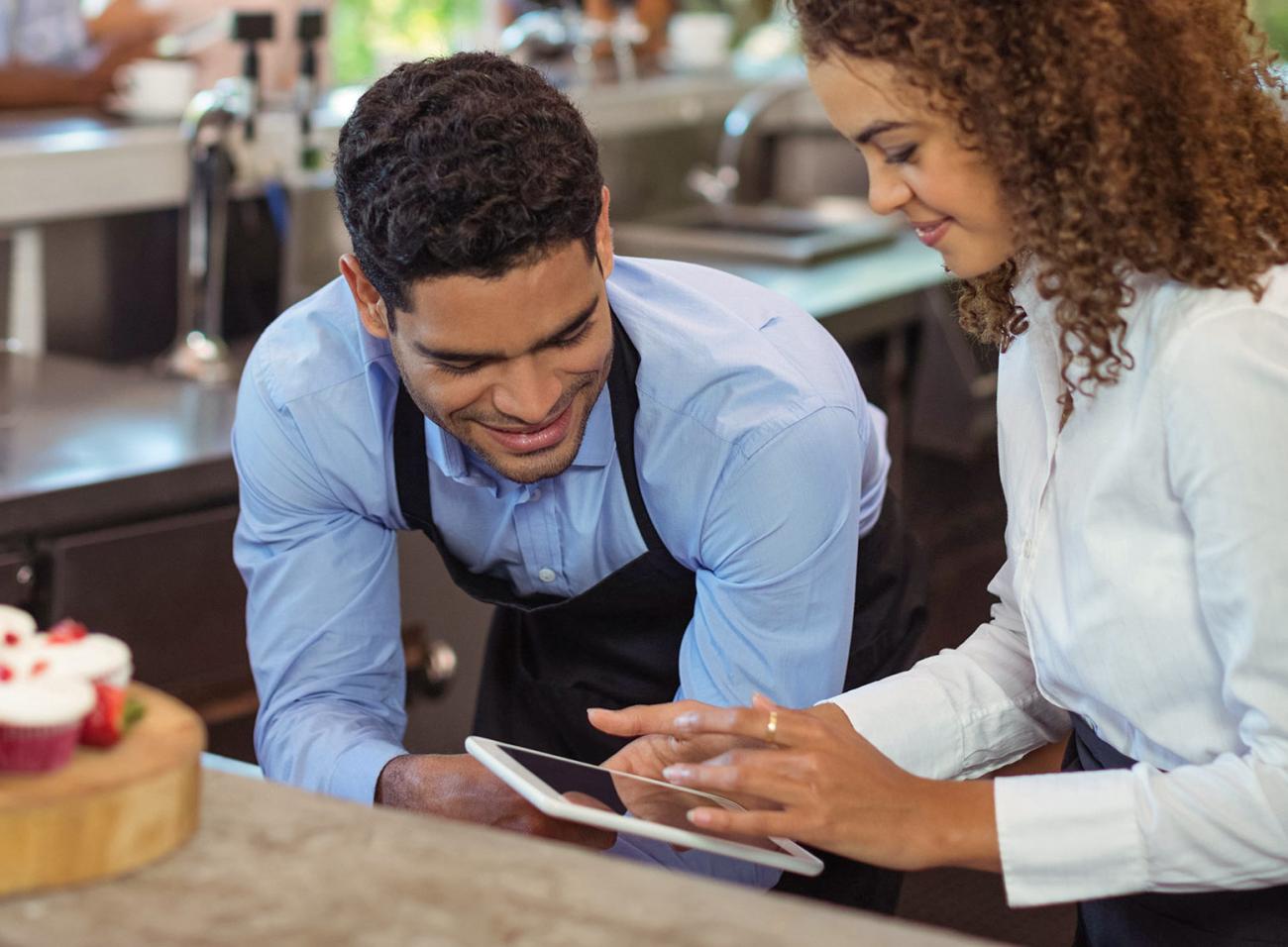 Bar staff consulting with manager