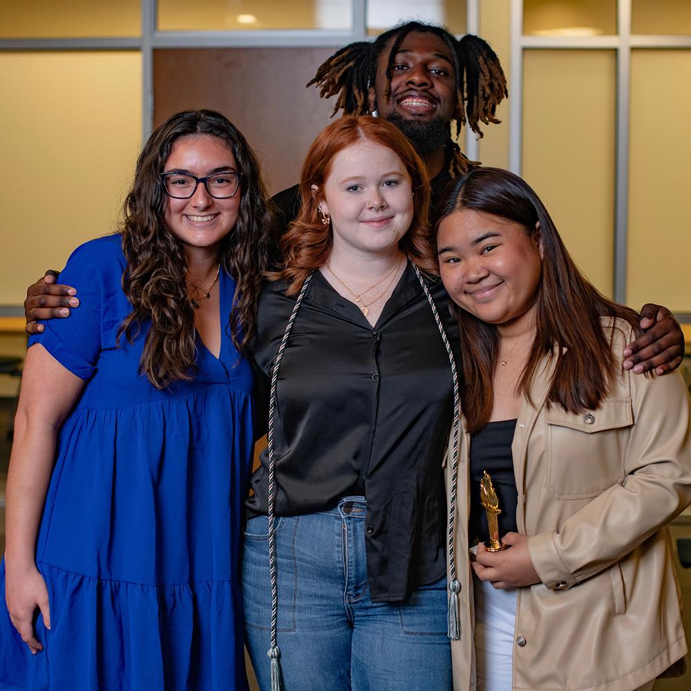 Four students pose together for a photo.