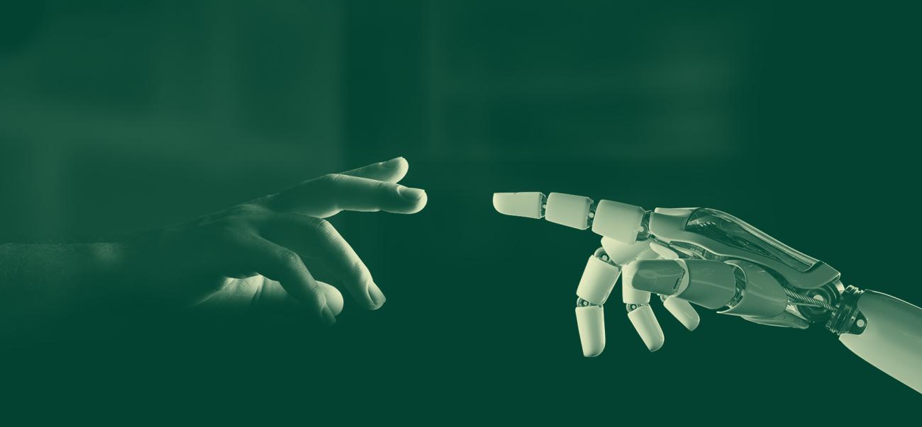A human hand and a robotic hand point toward each other