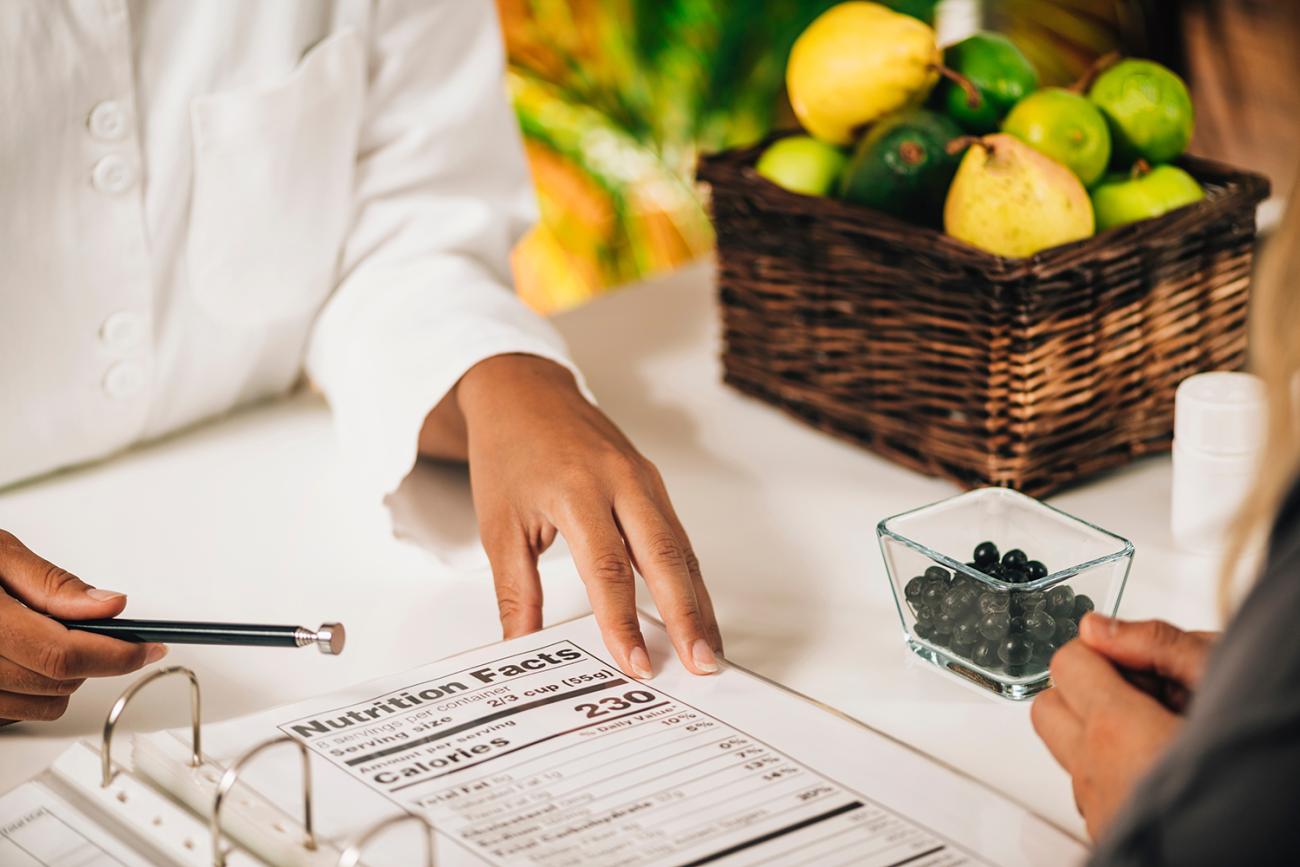 dietitian pointing at calorie chart