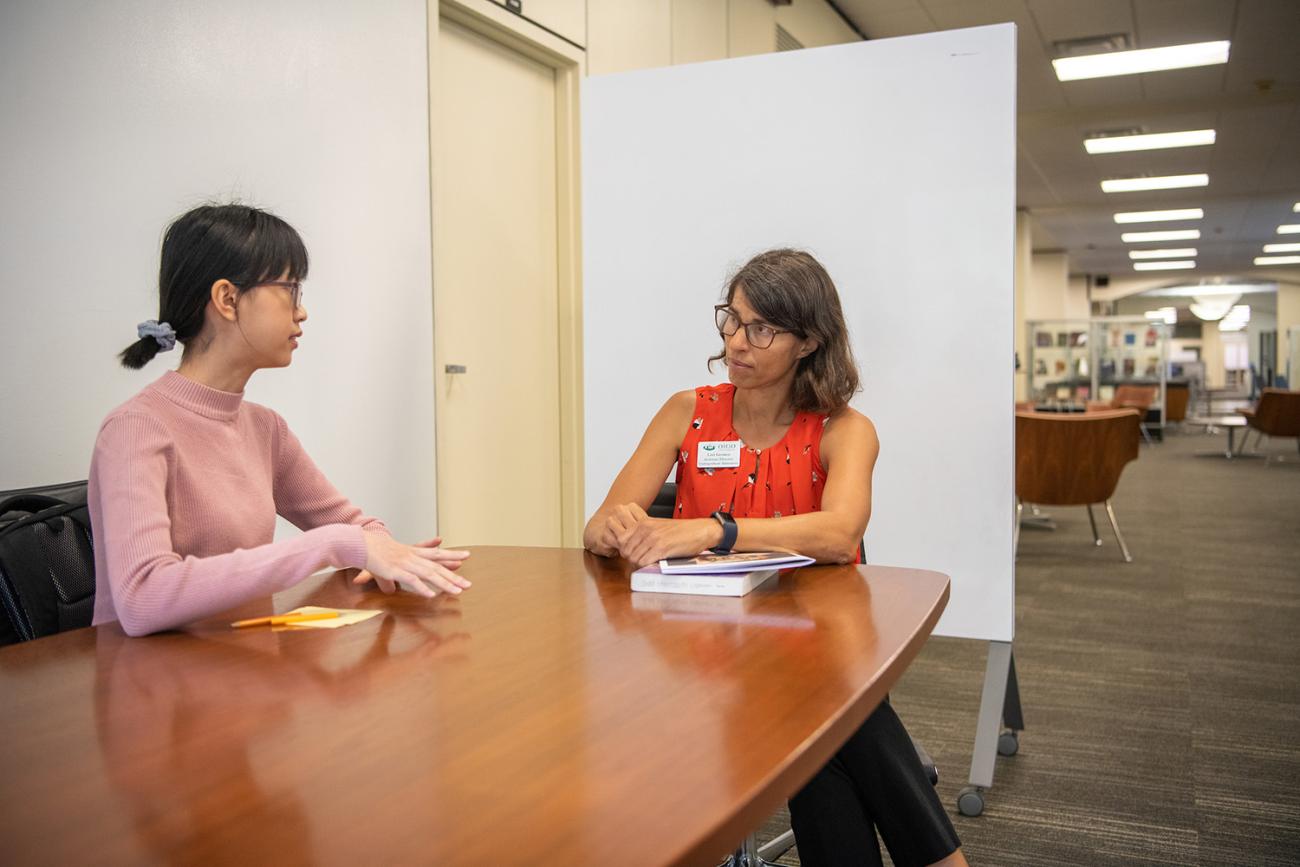 Two international students studying in Alden Library.