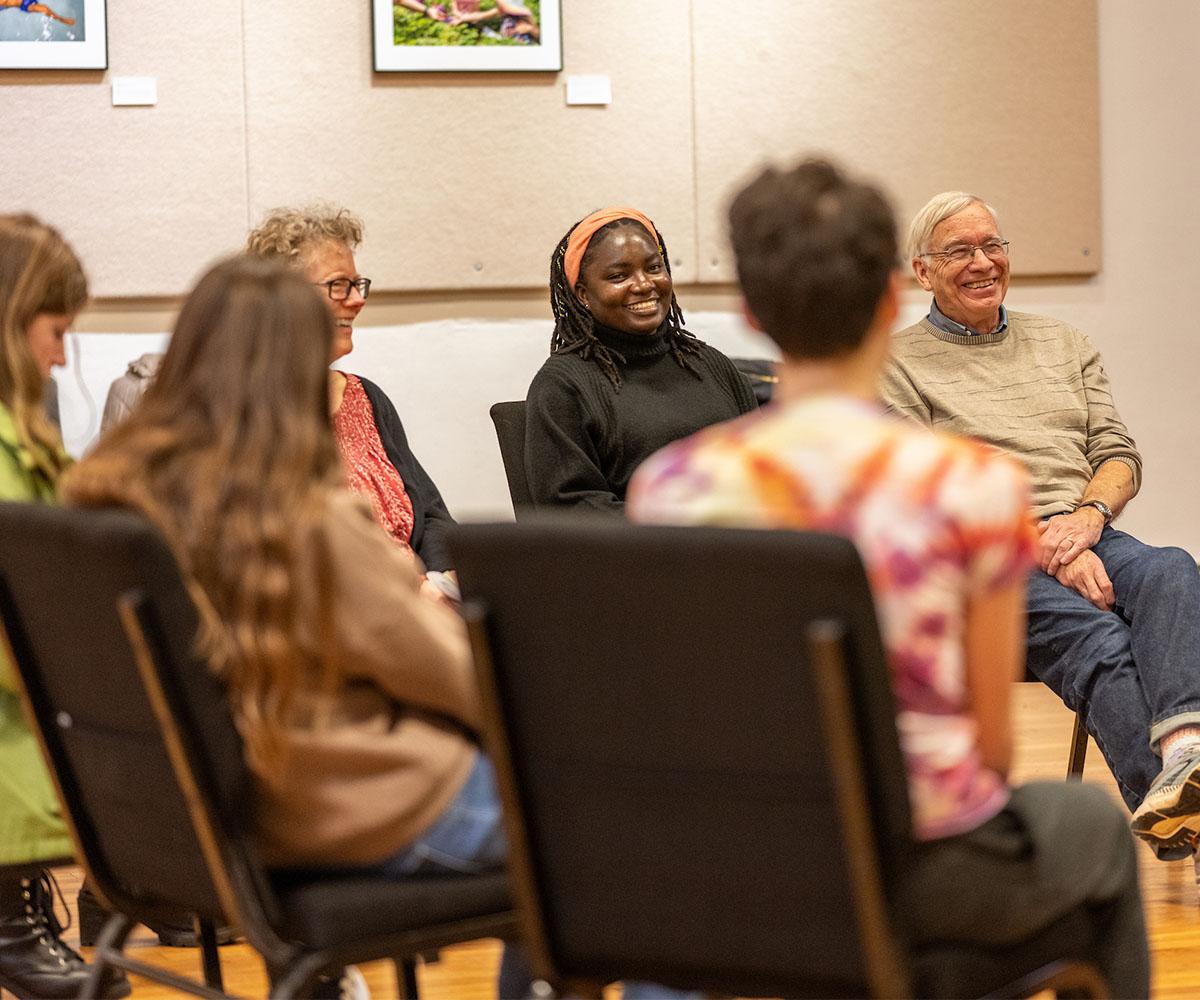 Students, faculty and staff talk to one another during a workshop.