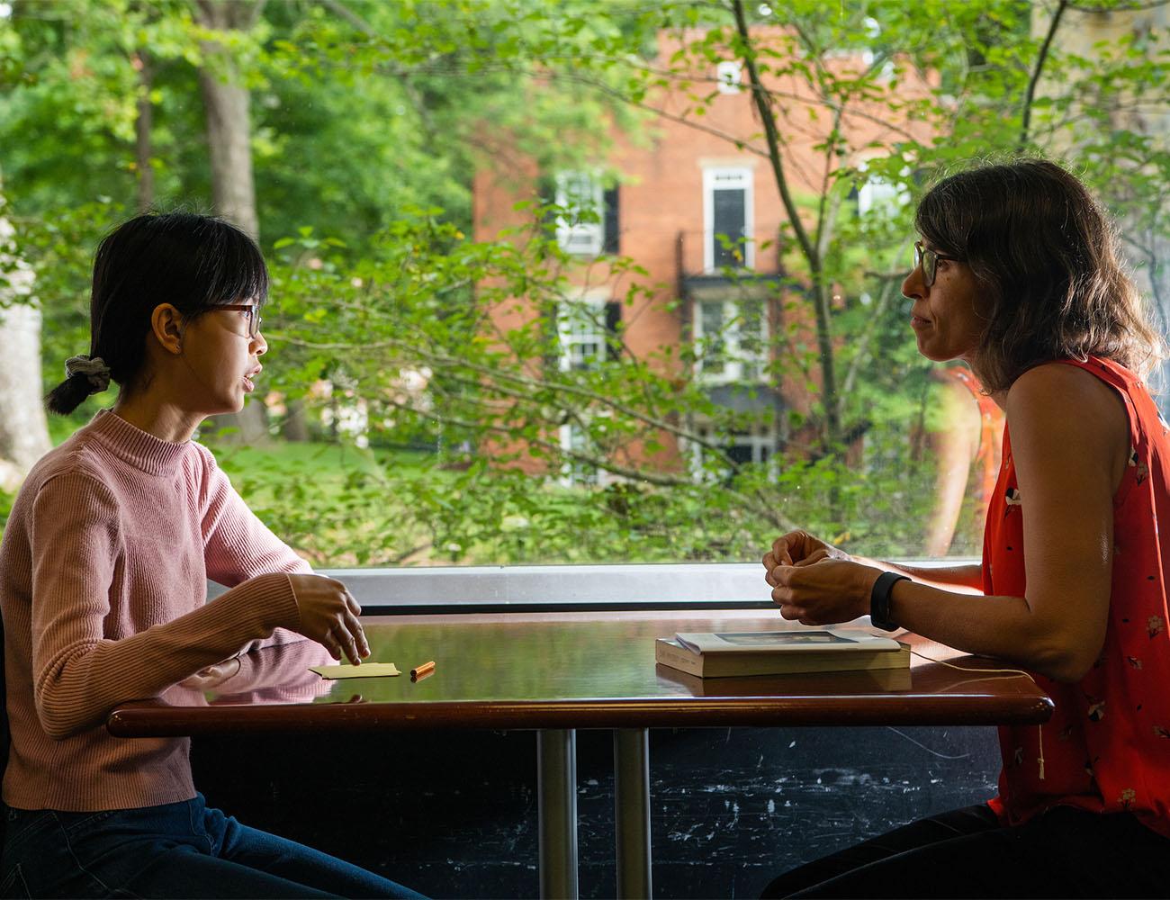 An advisor talks with a student.