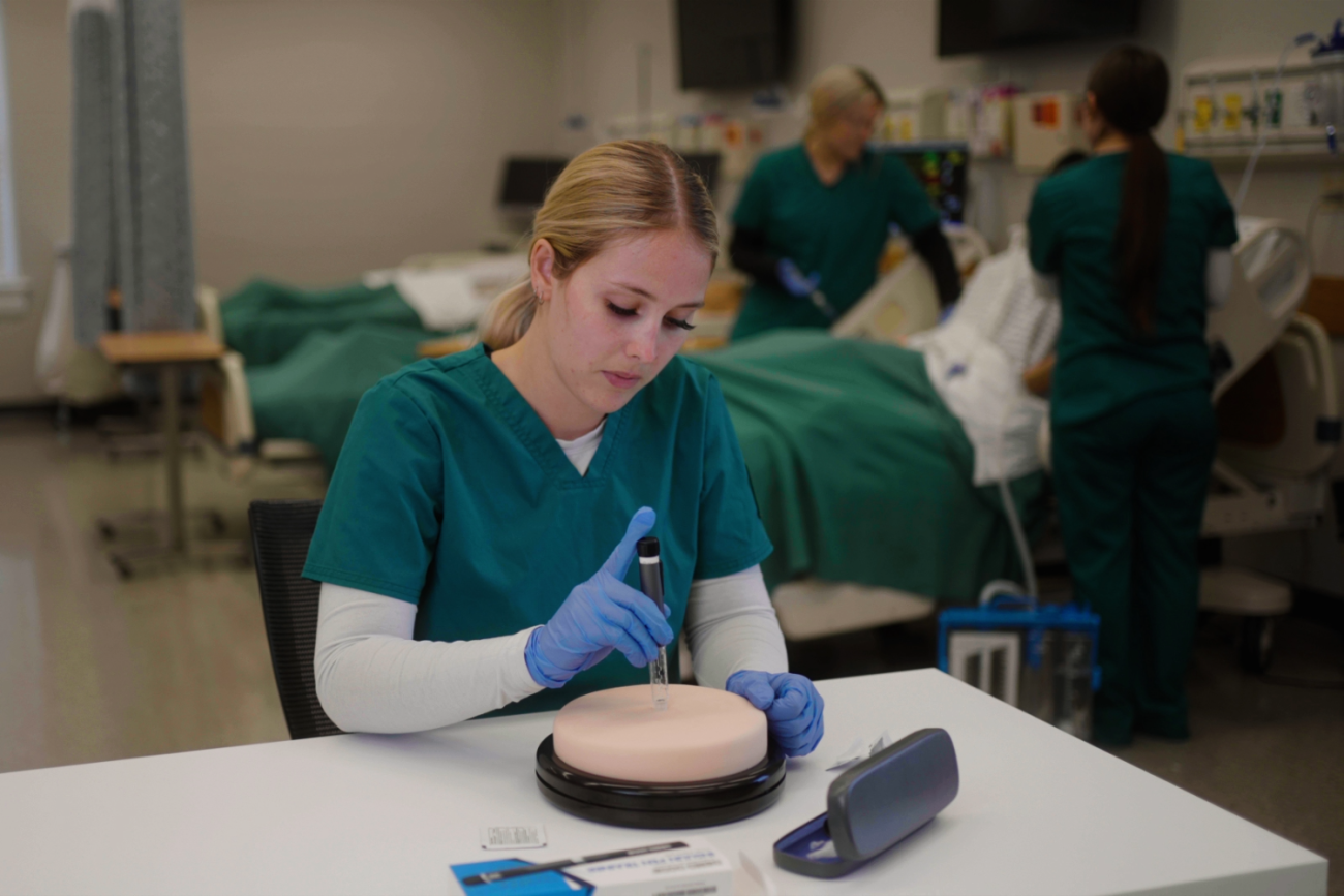 Nursing student practicing giving an injection