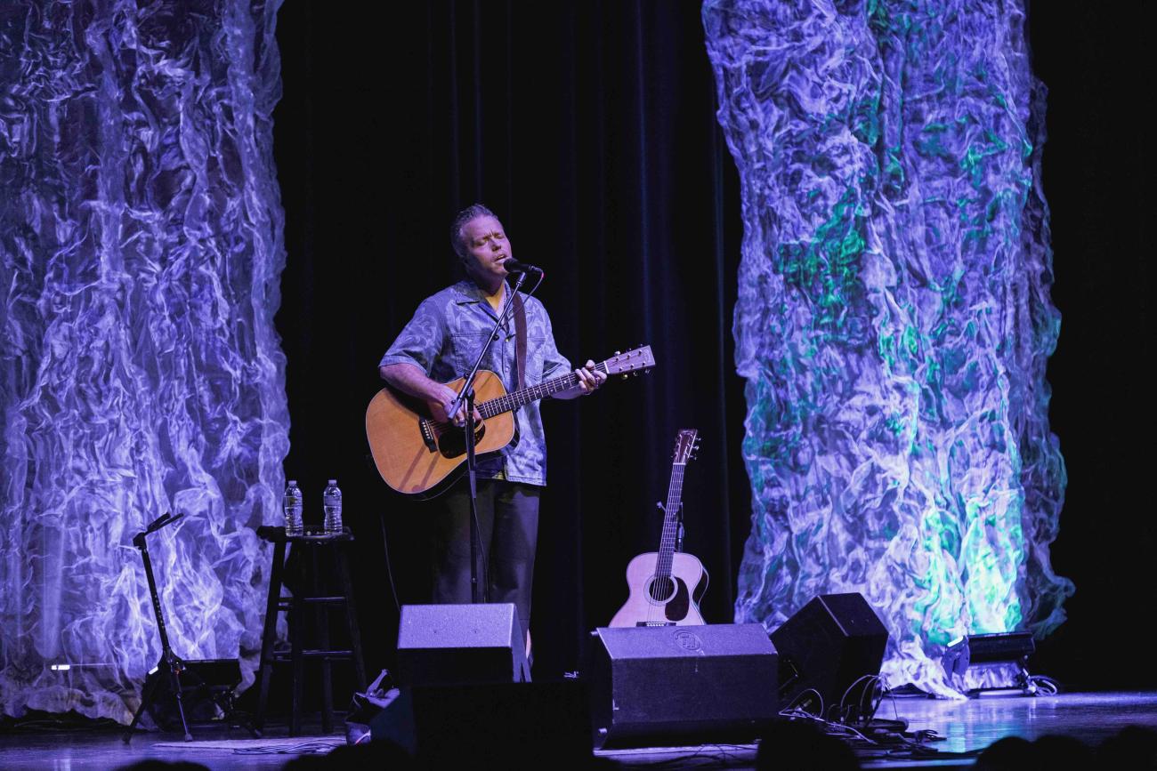 Jason Isbell singing and playing guitar solo on stage