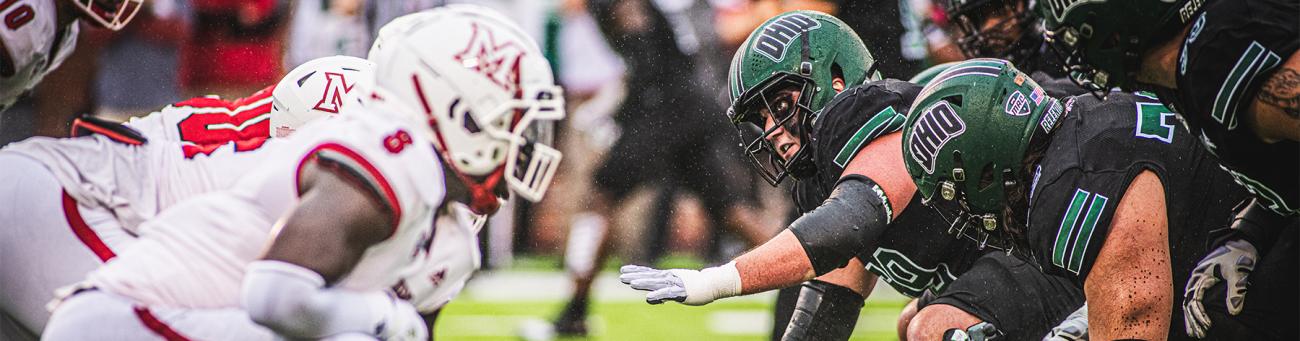 Ohio University football players face off against Miami University (Ohio) football players.