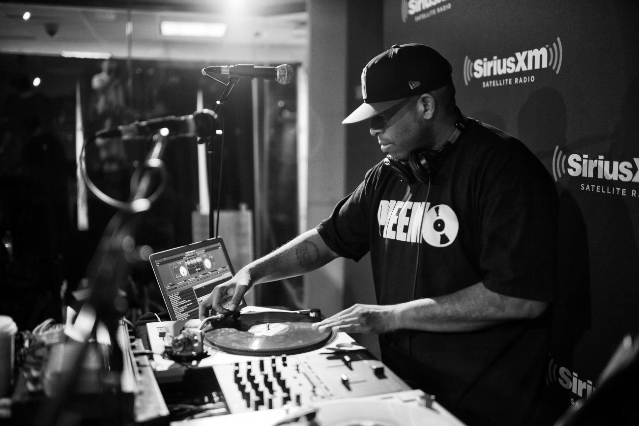 DJ Premier spinning records at a turntable