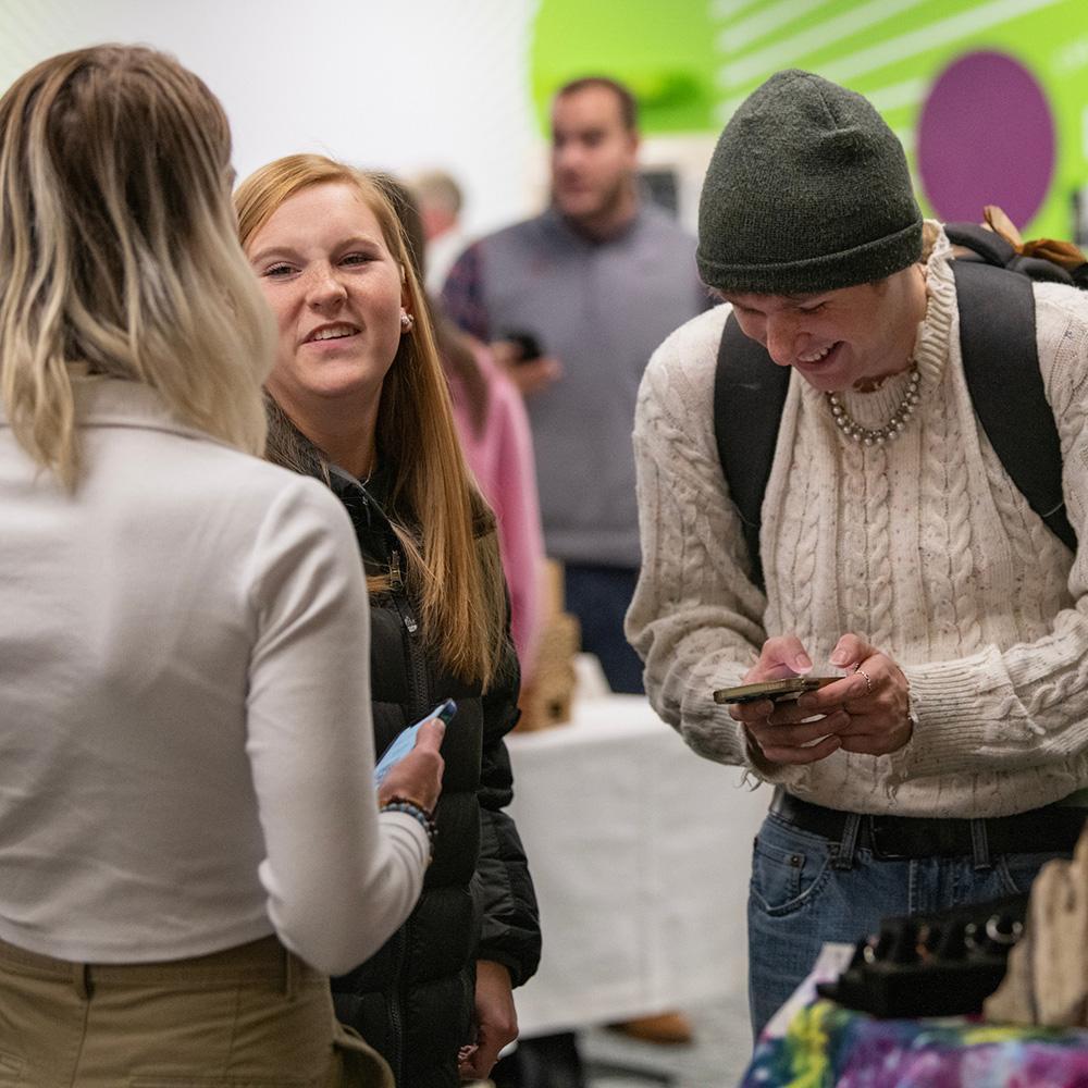 Students smile and interact at a conference