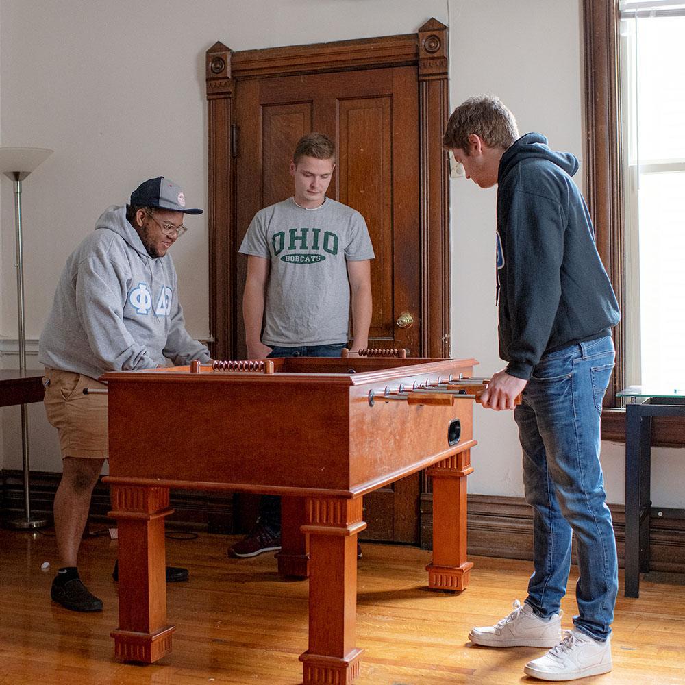 Students play foosball together