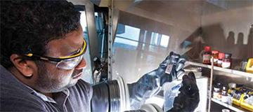 A researcher interacts with chemicals in a laboratory