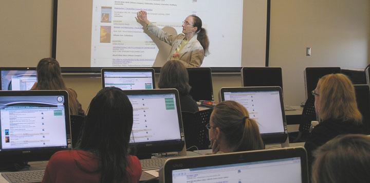 Woman lecturing in a computer lab