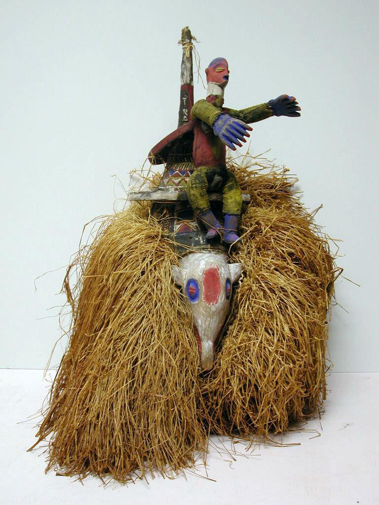 Headdress with Female Figure,  20th c.,  Yaka, Democratic Republic of Congo,  wood, cloth, raffia, paint,  27 x 16 x 16in ( 68.6 x 40.6 x 40.6cm),  83.065.B6.