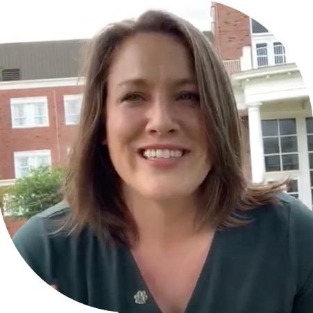 Headshot of Jenn Bennett, Executive Director of Wellbeing, in front of Grover Center