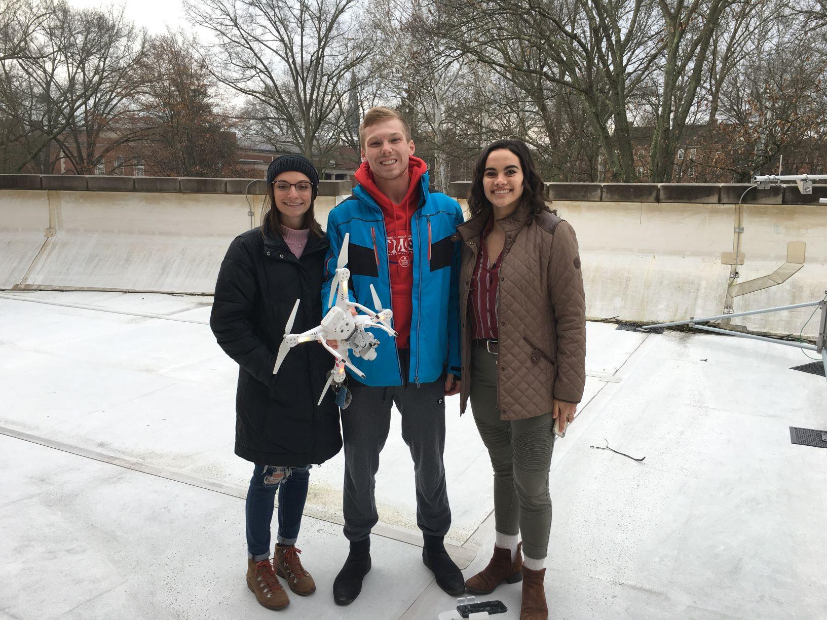 3 students on a roof